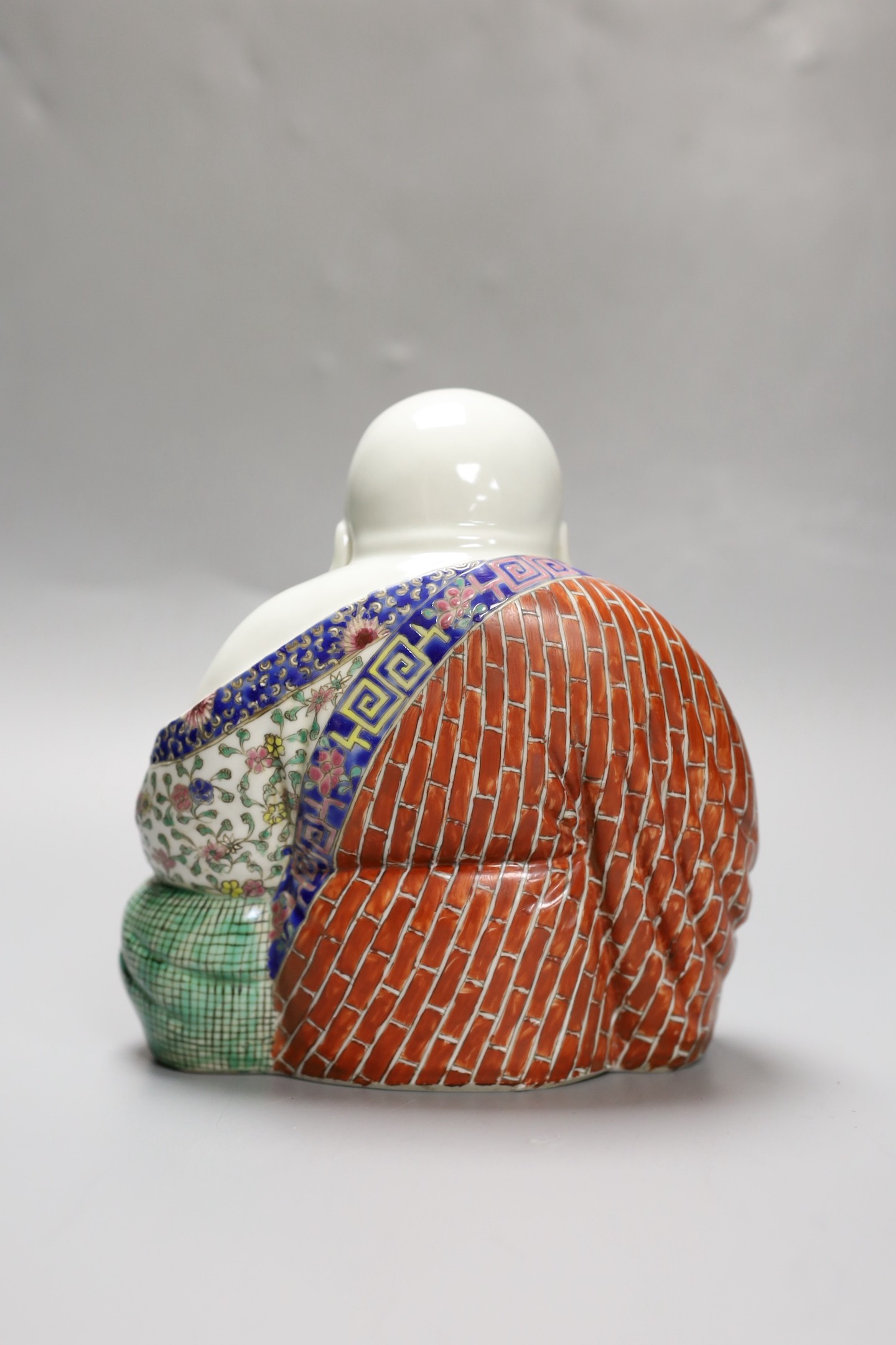 A Chinese enamelled porcelain seated Buddha, 19cm